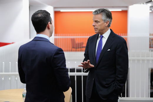 Former US Ambassador to China Jon Huntsman talks to an employee at GLG.